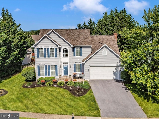 6810 Morrow Way, Frederick, MD 21703 - colonial house featuring driveway, an attached garage, a front yard, and a chimney