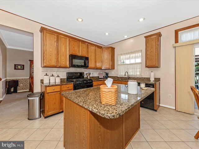 6810 Morrow Way, Frederick, MD 21703 - kitchen featuring black appliances, brown cabinets, light tile patterned floors, dark stone counters, and ornamental molding
