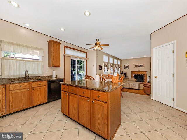 6810 Morrow Way, Frederick, MD 21703 - kitchen with black dishwasher, a sink, ceiling fan, light tile patterned flooring, and brown cabinetry