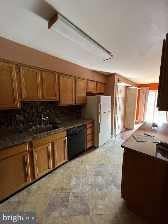 745 Cedar Ct, Red Hill, PA 18076 - kitchen with black dishwasher, brown cabinetry, freestanding refrigerator, stone finish floors, and tasteful backsplash