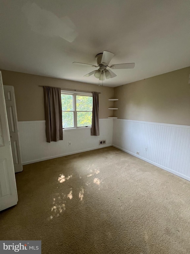 745 Cedar Ct, Red Hill, PA 18076 - unfurnished room featuring a wainscoted wall, ceiling fan, and carpet floors