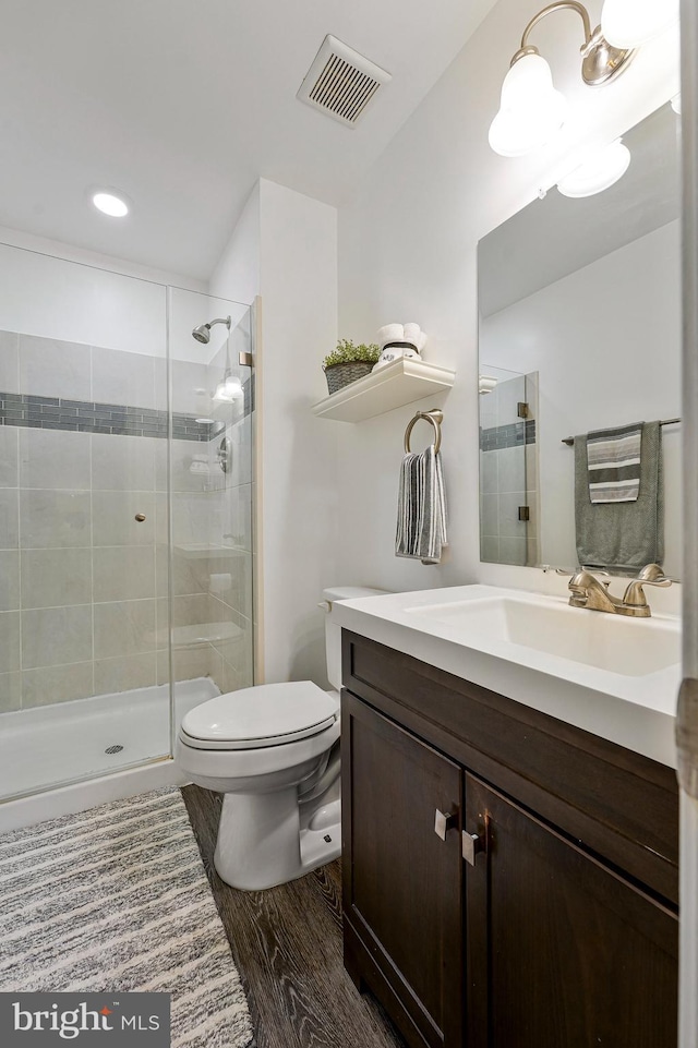 1085 Smartts Ln NE, Leesburg, VA 20176 - bathroom with vanity, toilet, a stall shower, wood finished floors, and recessed lighting