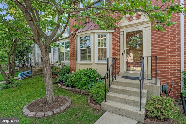 1085 Smartts Ln NE, Leesburg, VA 20176 - property entrance with brick siding and a yard