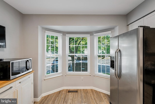 1085 Smartts Ln NE, Leesburg, VA 20176 - kitchen with appliances with stainless steel finishes, light wood-style floors, baseboards, wooden counters, and white cabinetry