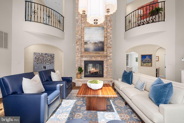 777 3rd St, Herndon, VA 20170 - living area with arched walkways, a high ceiling, a fireplace, and wood finished floors