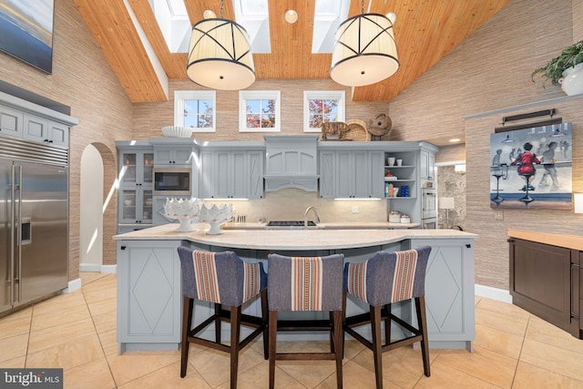 777 3rd St, Herndon, VA 20170 - kitchen with appliances with stainless steel finishes, high vaulted ceiling, wooden ceiling, light tile patterned flooring, and light countertops