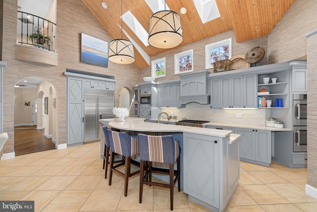 777 3rd St, Herndon, VA 20170 - kitchen with high vaulted ceiling, gray cabinetry, a skylight, appliances with stainless steel finishes, and wood ceiling