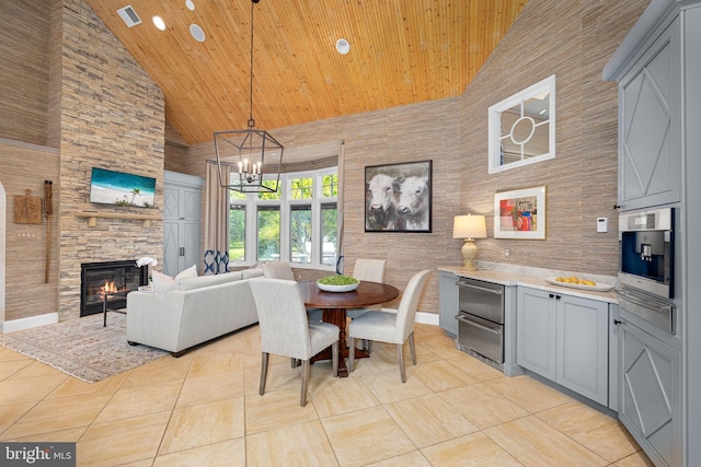 777 3rd St, Herndon, VA 20170 - dining area featuring high vaulted ceiling, wood ceiling, light tile patterned flooring, a chandelier, and a fireplace