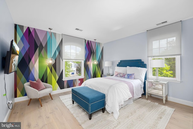 777 3rd St, Herndon, VA 20170 - bedroom with baseboards, an accent wall, multiple windows, and wood finished floors