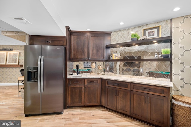 777 3rd St, Herndon, VA 20170 - kitchen with stainless steel refrigerator with ice dispenser, wallpapered walls, light wood finished floors, light stone countertops, and dark brown cabinetry