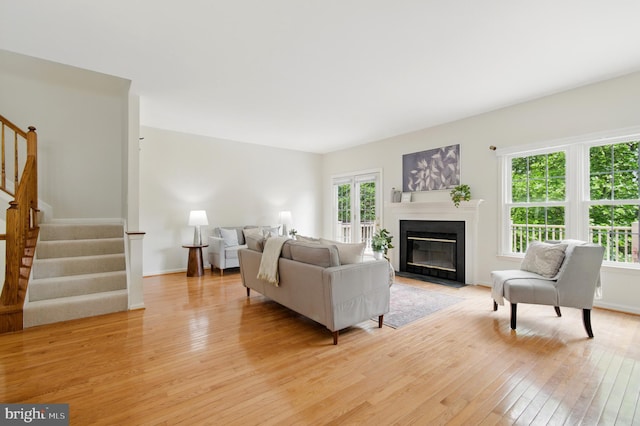 6201 Knolls Ct, Elkridge, MD 21075 - living room featuring light wood-type flooring, healthy amount of natural light, stairway, and a fireplace with flush hearth