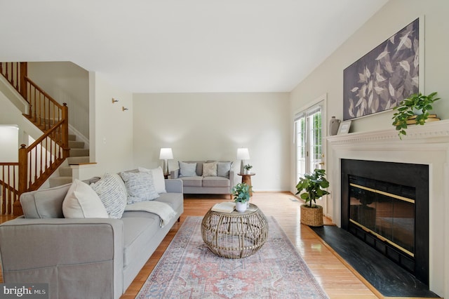 6201 Knolls Ct, Elkridge, MD 21075 - living room featuring wood finished floors, stairway, a fireplace with flush hearth, and baseboards