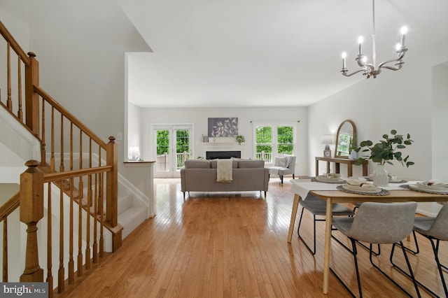 6201 Knolls Ct, Elkridge, MD 21075 - dining space with stairway, a chandelier, light wood-style flooring, and a fireplace