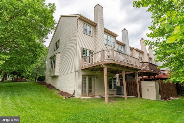 6201 Knolls Ct, Elkridge, MD 21075 - rear view of house with a wooden deck, a yard, central AC unit, and a chimney