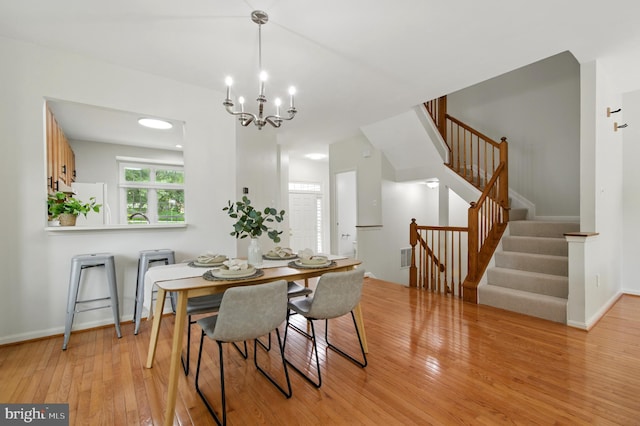 6201 Knolls Ct, Elkridge, MD 21075 - dining space featuring light wood-type flooring, stairway, a chandelier, and baseboards