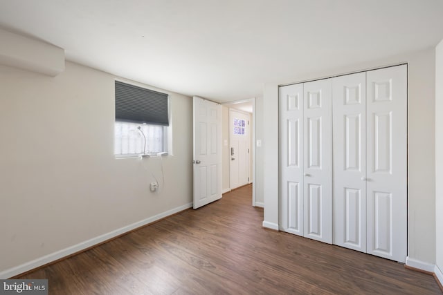 4909 Meade St NE, Washington, DC 20019 - unfurnished bedroom featuring dark wood-style floors, baseboards, and a closet