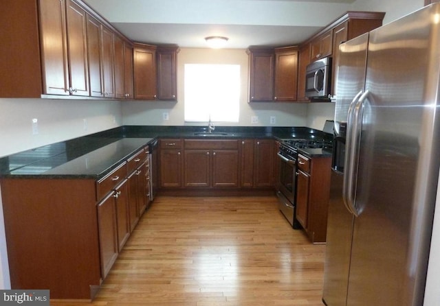 4909 Meade St NE, Washington, DC 20019 - kitchen with stainless steel appliances, a sink, and light wood-style floors