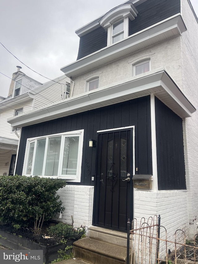 4839 Griscom St, Philadelphia, PA 19124 - doorway to property featuring brick siding and board and batten siding