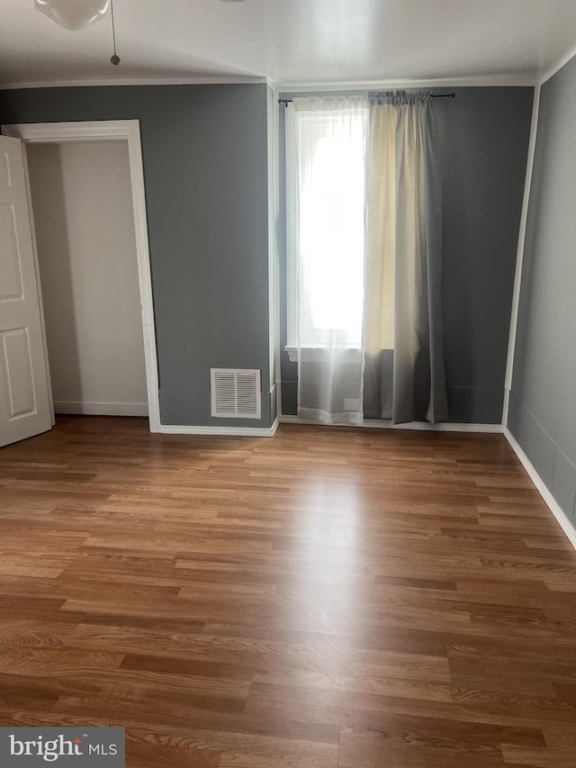 4839 Griscom St, Philadelphia, PA 19124 - unfurnished bedroom featuring ornamental molding, wood finished floors, and baseboards