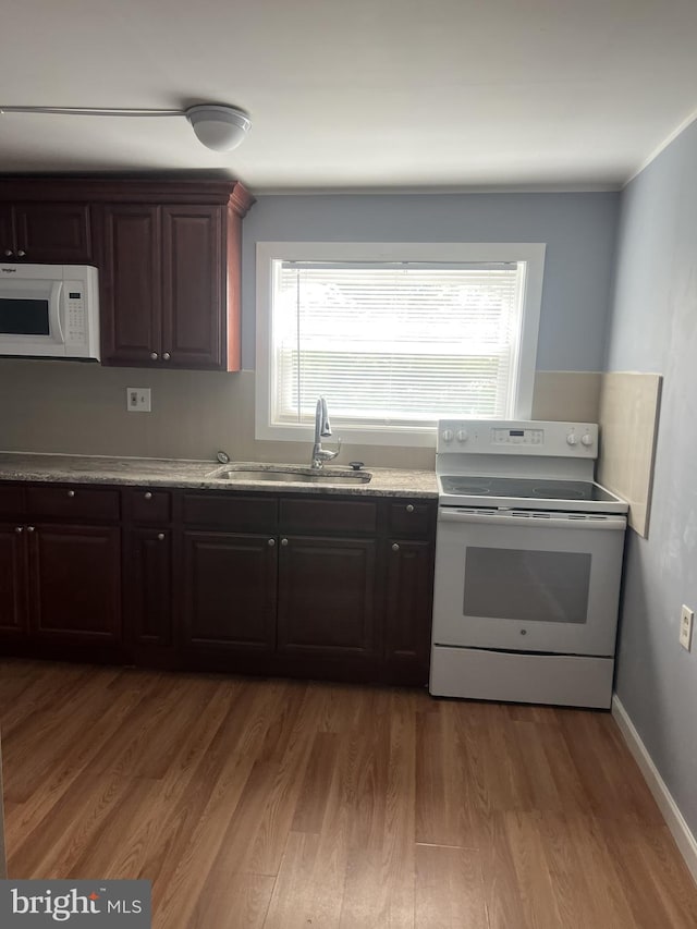 4839 Griscom St, Philadelphia, PA 19124 - kitchen featuring white appliances, light wood-style flooring, a sink, and plenty of natural light