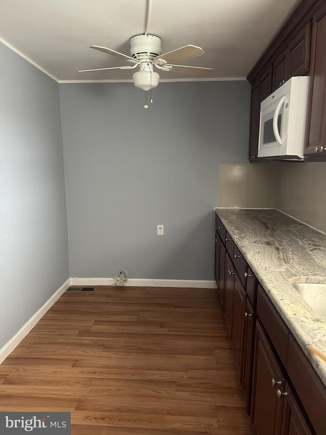 4839 Griscom St, Philadelphia, PA 19124 - kitchen featuring white microwave, ceiling fan, ornamental molding, light wood-style flooring, and baseboards