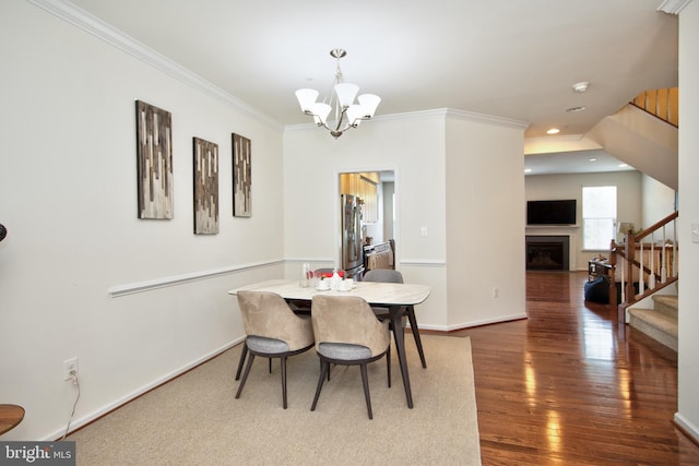 714 Shady Creek Ct, Bel Air, MD 21015 - dining space featuring stairs, a chandelier, ornamental molding, wood finished floors, and baseboards