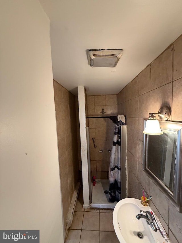 2338 W Hagert St, Philadelphia, PA 19132 - full bathroom featuring a stall shower, tile walls, and tile patterned flooring
