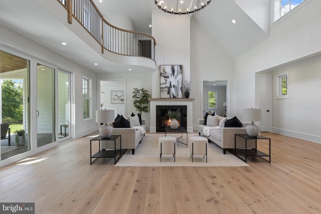 3718 Gradyville Rd, Newtown Square, PA 19073 - living area featuring a high ceiling, healthy amount of natural light, wood finished floors, a warm lit fireplace, and recessed lighting