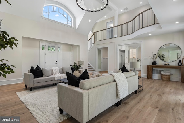 3718 Gradyville Rd, Newtown Square, PA 19073 - living room with stairs, a towering ceiling, light wood finished floors, recessed lighting, and baseboards