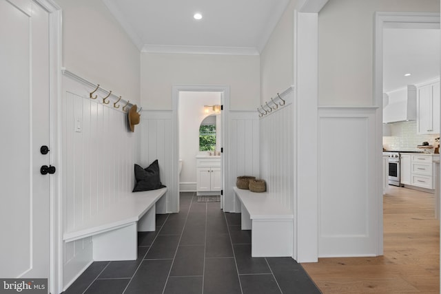 3718 Gradyville Rd, Newtown Square, PA 19073 - mudroom featuring wainscoting, a decorative wall, ornamental molding, and dark tile patterned floors
