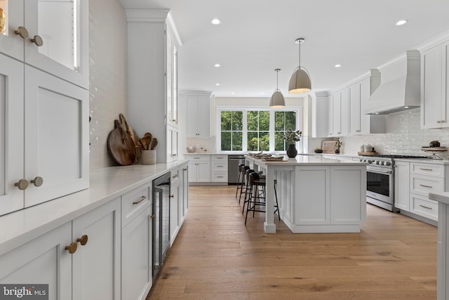 3718 Gradyville Rd, Newtown Square, PA 19073 - kitchen featuring custom range hood, stainless steel appliances, backsplash, white cabinetry, and light countertops
