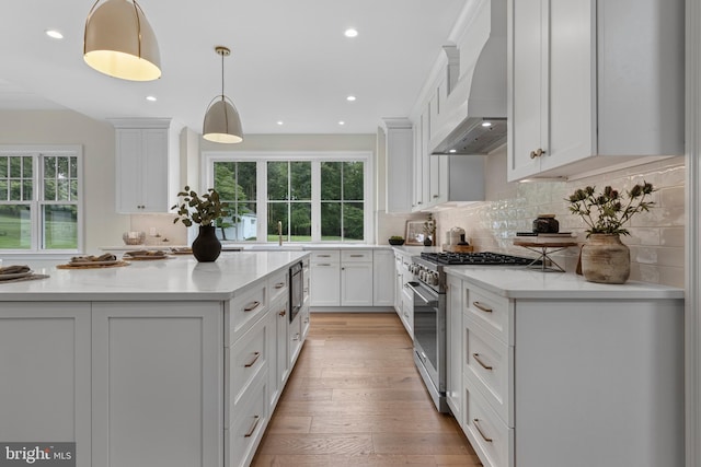 3718 Gradyville Rd, Newtown Square, PA 19073 - kitchen featuring wall chimney range hood, high end range, healthy amount of natural light, recessed lighting, and tasteful backsplash