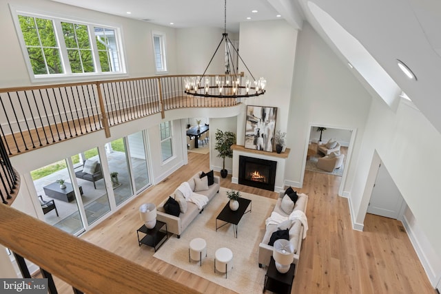 3718 Gradyville Rd, Newtown Square, PA 19073 - living area featuring a high ceiling, wood finished floors, a chandelier, healthy amount of natural light, and baseboards
