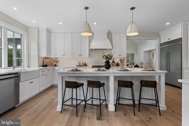 3718 Gradyville Rd, Newtown Square, PA 19073 - kitchen featuring built in fridge, custom exhaust hood, stainless steel dishwasher, white cabinetry, and recessed lighting