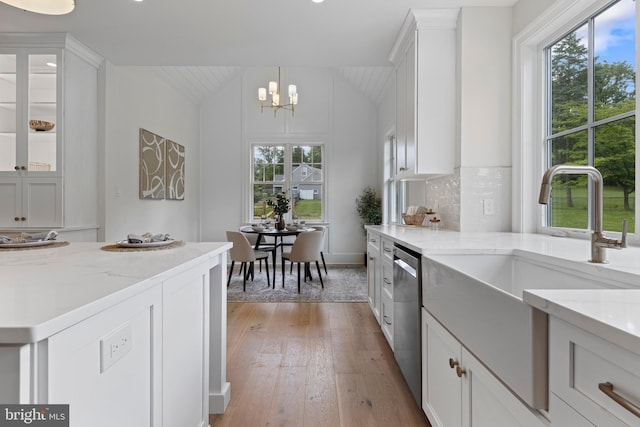 3718 Gradyville Rd, Newtown Square, PA 19073 - kitchen with vaulted ceiling, healthy amount of natural light, light wood finished floors, a sink, and white cabinetry