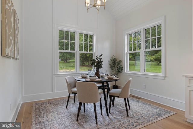 3718 Gradyville Rd, Newtown Square, PA 19073 - dining area with vaulted ceiling, a chandelier, healthy amount of natural light, and wood finished floors