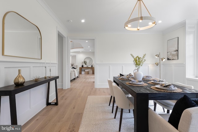 3718 Gradyville Rd, Newtown Square, PA 19073 - dining area with a decorative wall, crown molding, light wood-type flooring, a wainscoted wall, and a chandelier