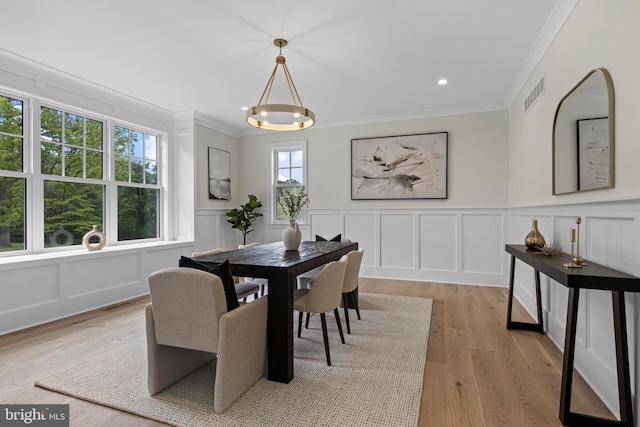 3718 Gradyville Rd, Newtown Square, PA 19073 - dining area with a decorative wall, crown molding, light wood-type flooring, a chandelier, and a wainscoted wall