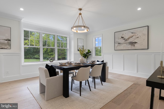 3718 Gradyville Rd, Newtown Square, PA 19073 - dining area featuring a decorative wall, crown molding, light wood-style flooring, and wainscoting