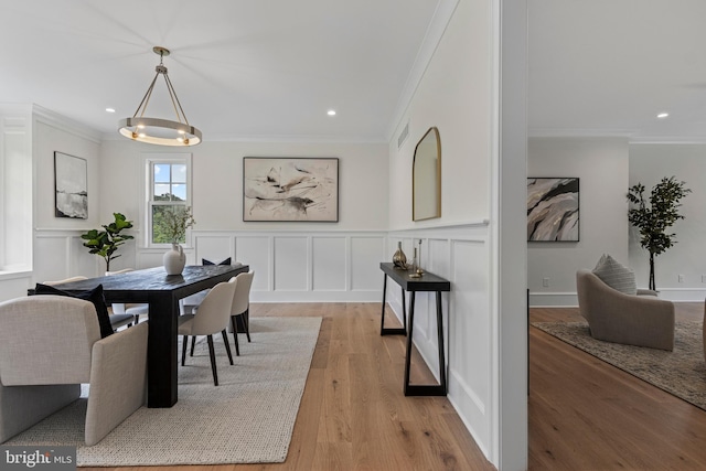 3718 Gradyville Rd, Newtown Square, PA 19073 - dining space featuring crown molding, light wood-type flooring, a decorative wall, recessed lighting, and wainscoting
