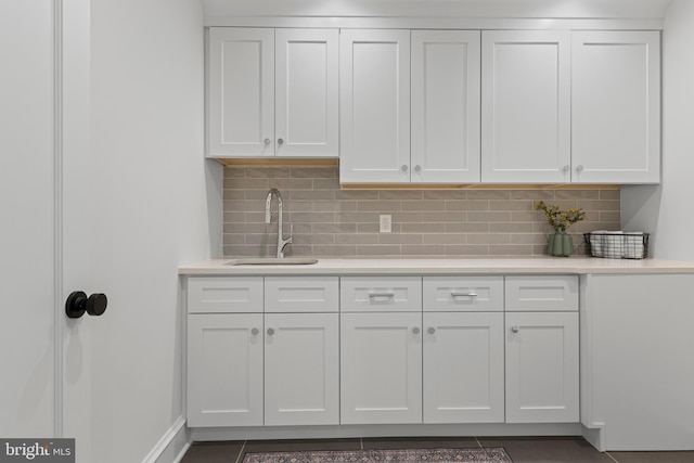 3718 Gradyville Rd, Newtown Square, PA 19073 - kitchen with a sink, white cabinetry, light countertops, and tasteful backsplash