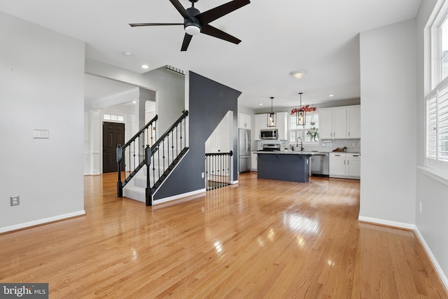 9901 Airedale Ct, Bristow, VA 20136 - unfurnished living room with ceiling fan, a sink, light wood-type flooring, baseboards, and recessed lighting