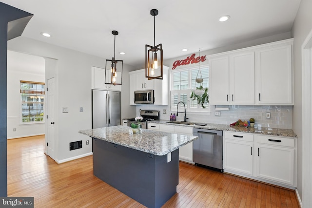 9901 Airedale Ct, Bristow, VA 20136 - kitchen with stainless steel appliances, light wood-style floors, a sink, healthy amount of natural light, and recessed lighting
