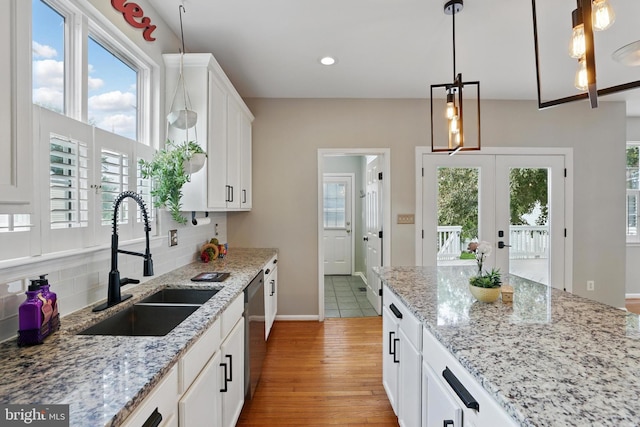 9901 Airedale Ct, Bristow, VA 20136 - kitchen with a sink, light wood-style floors, dishwasher, backsplash, and healthy amount of natural light