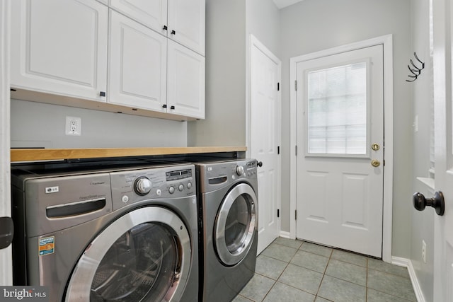 9901 Airedale Ct, Bristow, VA 20136 - laundry room featuring cabinet space, separate washer and dryer, light tile patterned floors, and baseboards