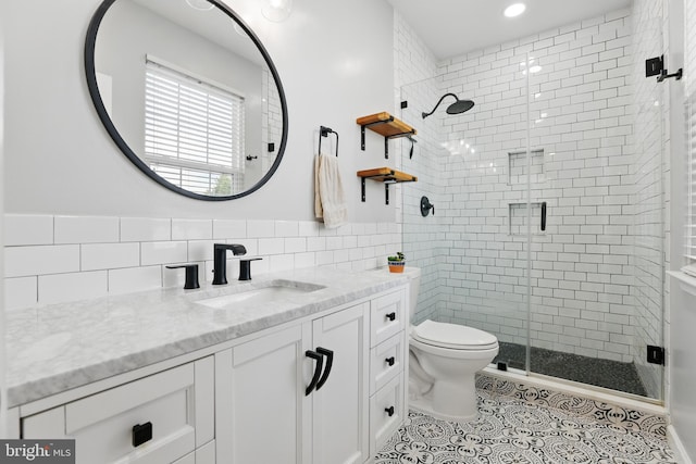 9901 Airedale Ct, Bristow, VA 20136 - bathroom featuring tile walls, vanity, toilet, a stall shower, and tile patterned floors