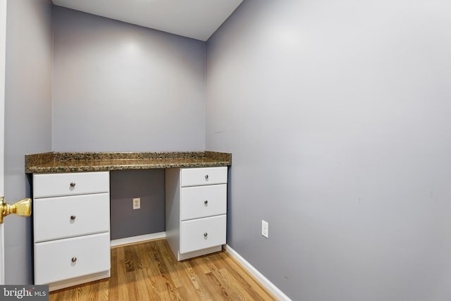 9901 Airedale Ct, Bristow, VA 20136 - unfurnished office with light wood-style floors, baseboards, and built in desk