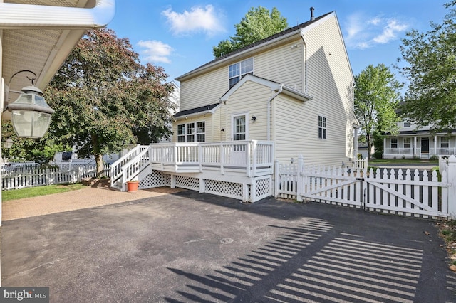 9901 Airedale Ct, Bristow, VA 20136 - back of house featuring a wooden deck and a gate