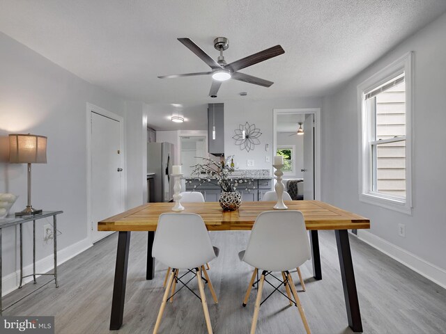 6202 K St, Capitol Heights, MD 20743 - dining space with ceiling fan, light wood finished floors, baseboards, and a textured ceiling