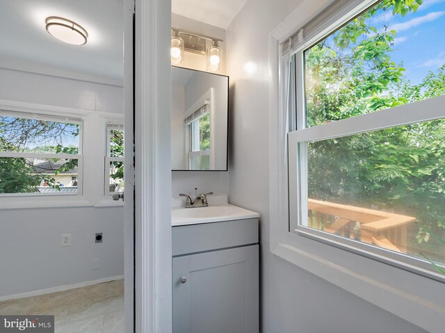 6202 K St, Capitol Heights, MD 20743 - bathroom with vanity, healthy amount of natural light, baseboards, and tile patterned flooring